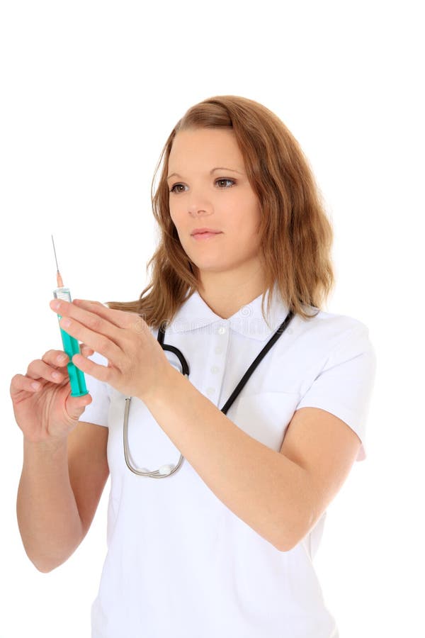 Attractive doctor prepares injection. All on white background. Attractive doctor prepares injection. All on white background.