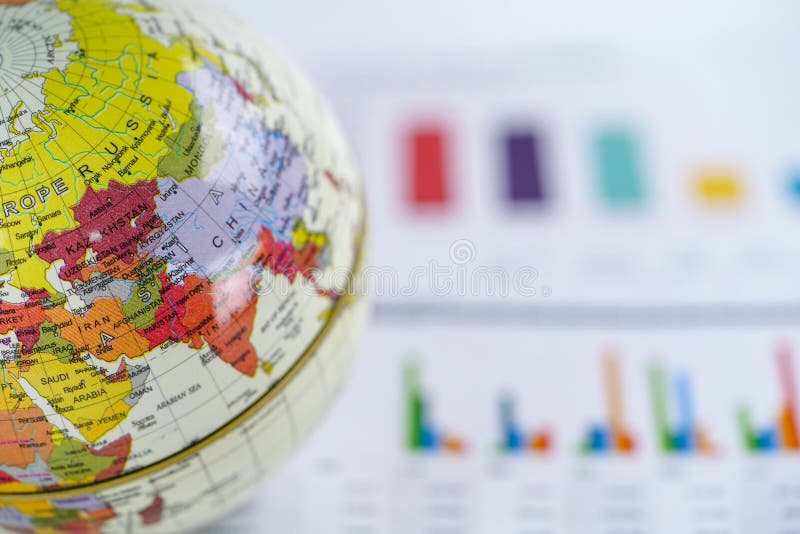 Globe world map on chart graph paper. Finance, Account, Statistics, Investment, Analytic research data economy and Business company meeting concept. Globe world map on chart graph paper. Finance, Account, Statistics, Investment, Analytic research data economy and Business company meeting concept.