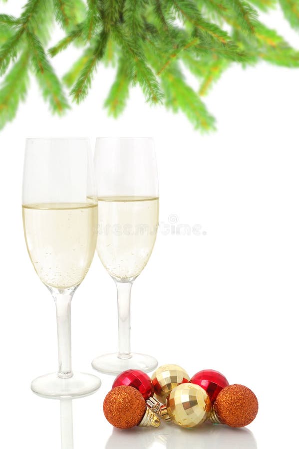Pair of champagne flutes and christmas balls against a white background. Pair of champagne flutes and christmas balls against a white background
