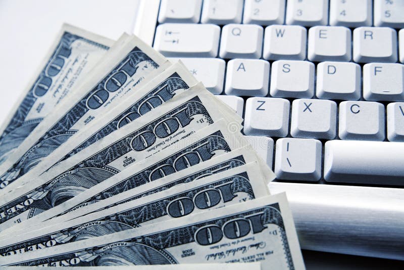 Dollar banknotes on a background an aluminium computer keyboard. Dollar banknotes on a background an aluminium computer keyboard
