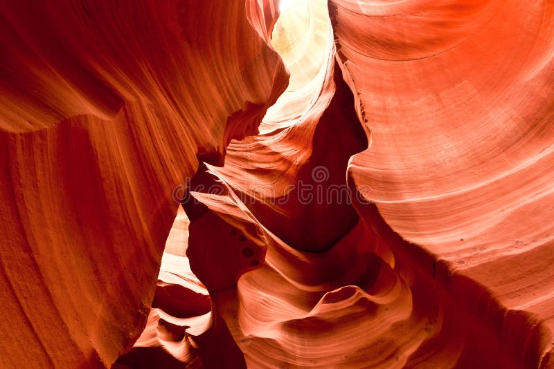 Antelope Canyon in Arizona is a narrow canyon with fantastic interior shapes created by swirling water and wind. Light enters only at the top, giving the red sandstone a warm glow, and illuminating purple-colored sections of stone. Antelope Canyon in Arizona is a narrow canyon with fantastic interior shapes created by swirling water and wind. Light enters only at the top, giving the red sandstone a warm glow, and illuminating purple-colored sections of stone.