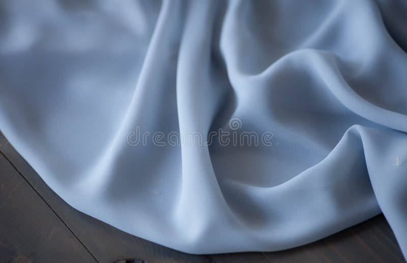 De blauwe achtergrond van de stoffentextuur, golvende stof stock foto De blauwe achtergrond van de stoffentextuur, golvende stof stock foto