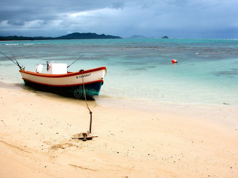 A resting boat along the shores of a beach on Oahu, Hawaii. A resting boat along the shores of a beach on Oahu, Hawaii.