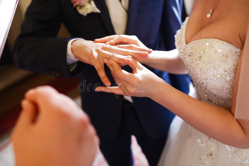 De bruid zet een ring tactvol op de vinger van de bruidegom royalty-vrije stock afbeelding De bruid zet een ring tactvol op de vinger van de bruidegom royalty-vrije stock afbeelding