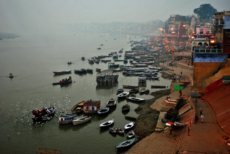 Tourists are watching the offering Ceremony of the Ganges River from boats on river at Varanasi, India. Banaras, is considered as the cultural capital of the oldest and holiest cities in India and home to the most famous Ghats (steps leading down to the river) in the country. There are more than 150 Ghats alongside Ganges in Banaras. Worshippers flock to these Ghats every day to bathe in the holy River Ganges which is believed to absolve one from all sins and then worship at the many temples lining the riverbank. Huge crowds of pilgrims and visitors from all parts of the world gather to take part in this ancient ritual which involves making offerings (puja) to the rising sun and is often watched by tourists who come to photograph this incredible sight. Banaras has been a traditional center of learning of philosophy, Sanskrit, astrology and religion. Tourists are watching the offering Ceremony of the Ganges River from boats on river at Varanasi, India. Banaras, is considered as the cultural capital of the oldest and holiest cities in India and home to the most famous Ghats (steps leading down to the river) in the country. There are more than 150 Ghats alongside Ganges in Banaras. Worshippers flock to these Ghats every day to bathe in the holy River Ganges which is believed to absolve one from all sins and then worship at the many temples lining the riverbank. Huge crowds of pilgrims and visitors from all parts of the world gather to take part in this ancient ritual which involves making offerings (puja) to the rising sun and is often watched by tourists who come to photograph this incredible sight. Banaras has been a traditional center of learning of philosophy, Sanskrit, astrology and religion.