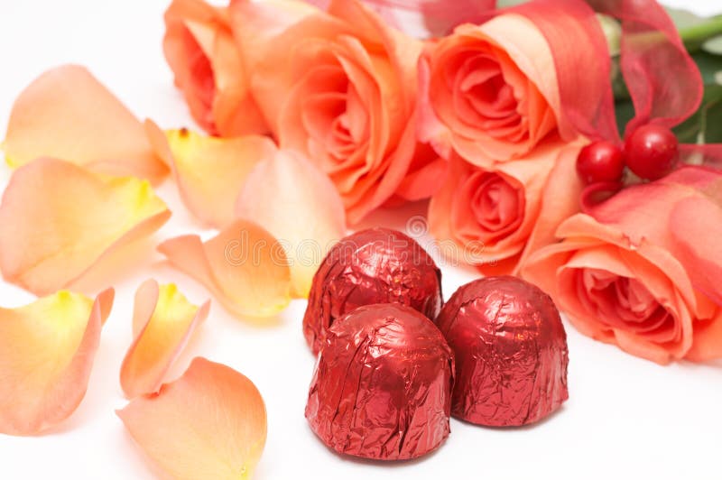 Valentines truffle chocolates with pink roses and petals on white. Valentines truffle chocolates with pink roses and petals on white