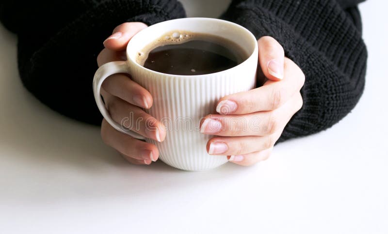 De close-up van vrouw dient de zwarte gebreide kop van de sweaterholding van koffie in De lege scène van het mokmodel De winteron royalty-vrije stock fotografie De close-up van vrouw dient de zwarte gebreide kop van de sweaterholding van koffie in De lege scène van het mokmodel De winteron royalty-vrije stock fotografie