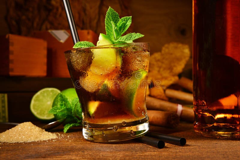 Cuba Libre Cocktail with Cigars on wooden Background. Cuba Libre Cocktail with Cigars on wooden Background
