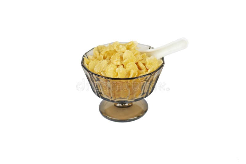 De cornflakes in een bruinachtig traditioneel glas werpen met tribune en een witte Chinese die lepel half in de cornflakes wordt royalty-vrije stock afbeelding De cornflakes in een bruinachtig traditioneel glas werpen met tribune en een witte Chinese die lepel half in de cornflakes wordt royalty-vrije stock afbeelding