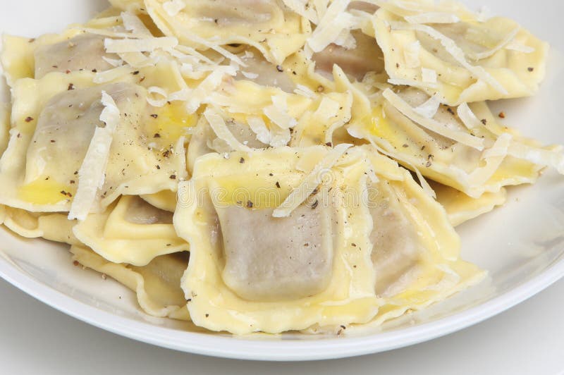 Ravioli pasta with shredded parmesan cheese, olive oil and freshly ground pepper. Ravioli pasta with shredded parmesan cheese, olive oil and freshly ground pepper