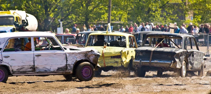 Three cars in a demolition derby. Three cars in a demolition derby.