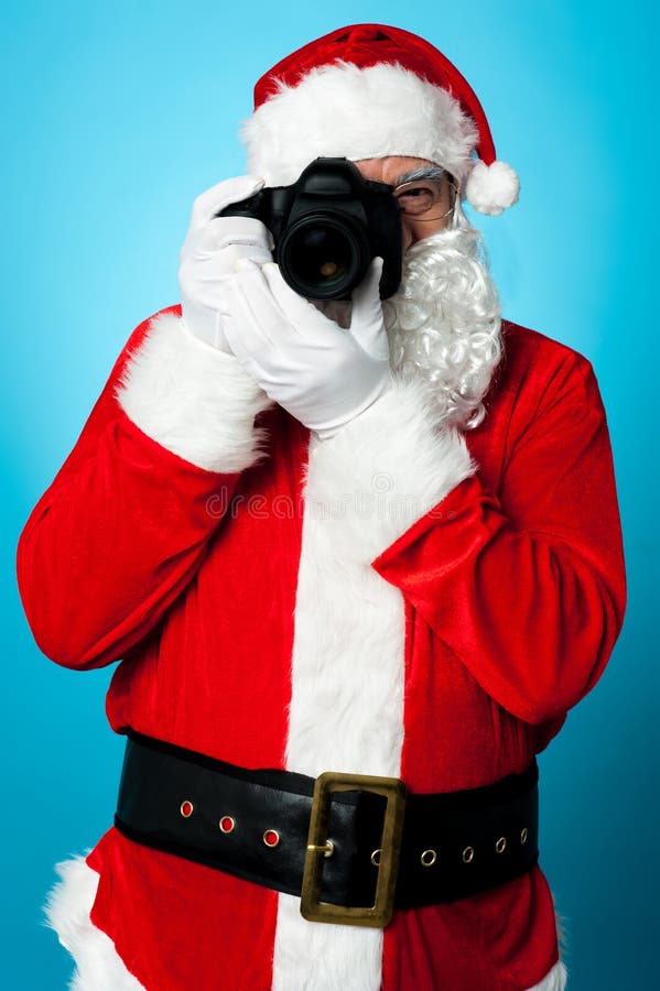 De draaien van de Kerstman in een profotograaf royalty-vrije stock foto De draaien van de Kerstman in een profotograaf royalty-vrije stock foto