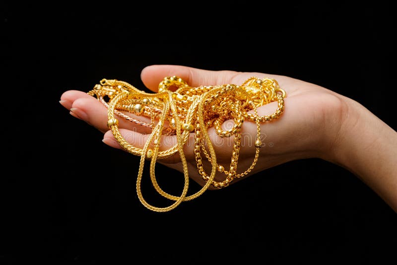 De Dure Gouden Juwelen van de handholding royalty-vrije stock afbeeldingen De Dure Gouden Juwelen van de handholding royalty-vrije stock afbeeldingen