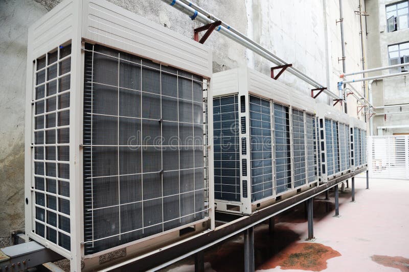 Air conditioner condenser unit outside a house. Air conditioner condenser unit outside a house.