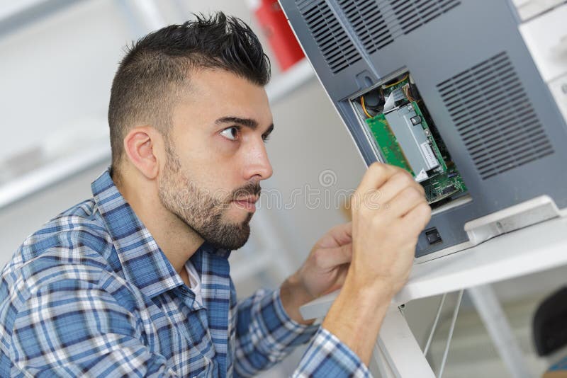 De elektricienwerken met elektronische machine stock afbeelding De elektricienwerken met elektronische machine stock afbeelding