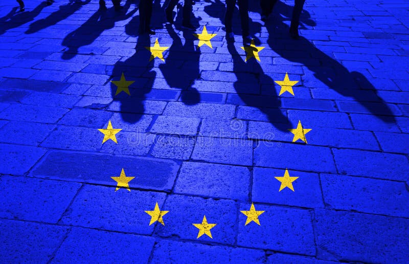 Grunge European Union flag with shadows of the crowd of walking people on stone tiled street floor. Grunge European Union flag with shadows of the crowd of walking people on stone tiled street floor.