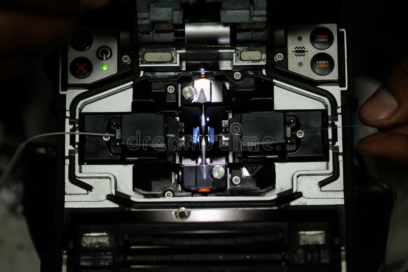 The photo of fusion splicer fiber optic. Working with fiber optic fusion splicer before connecting. The photo of fusion splicer fiber optic. Working with fiber optic fusion splicer before connecting.