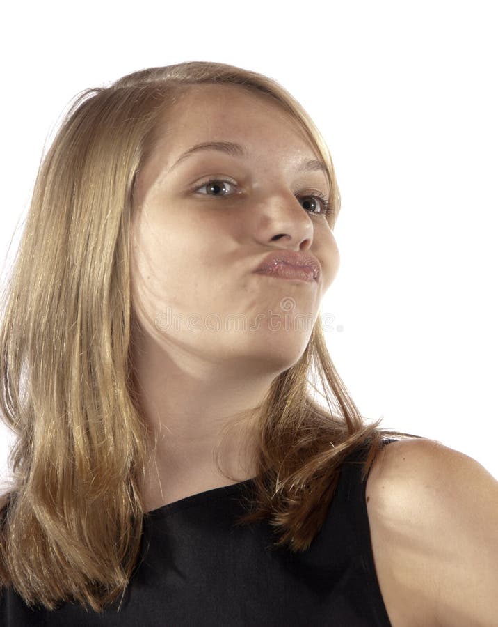 Young teenage girl sour look puckers up at the camera on white backgound in studio. Young teenage girl sour look puckers up at the camera on white backgound in studio.