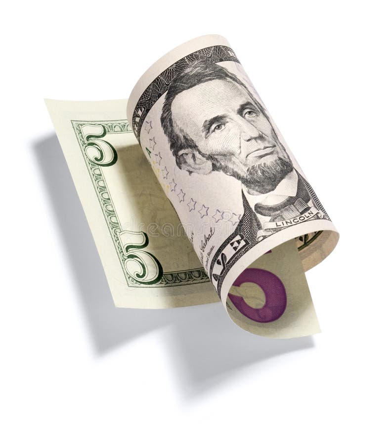 A rolled up five dollar bill isolated on a white background. A rolled up five dollar bill isolated on a white background