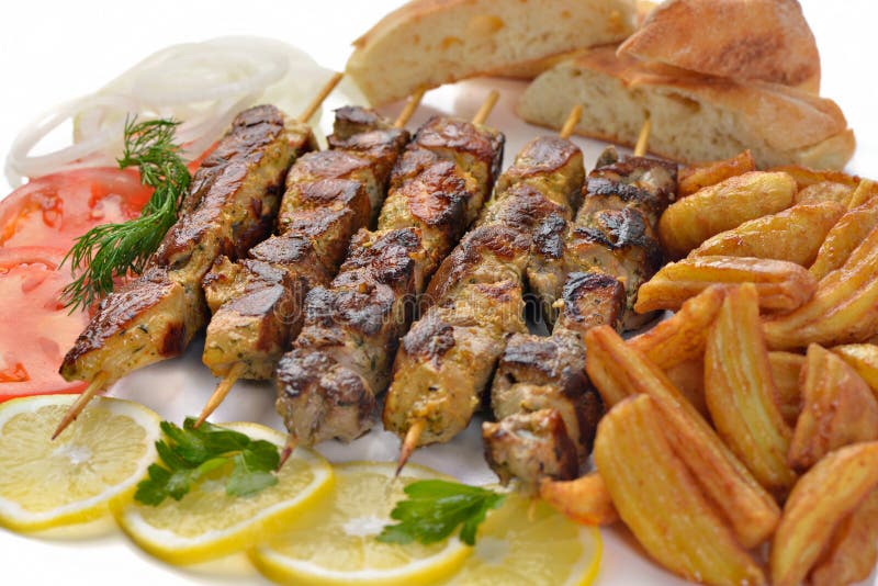 De Griekse ongezonde kost van de het vleessandwich van het souvlakivarkensvlees stock afbeeldingen De Griekse ongezonde kost van de het vleessandwich van het souvlakivarkensvlees stock afbeeldingen