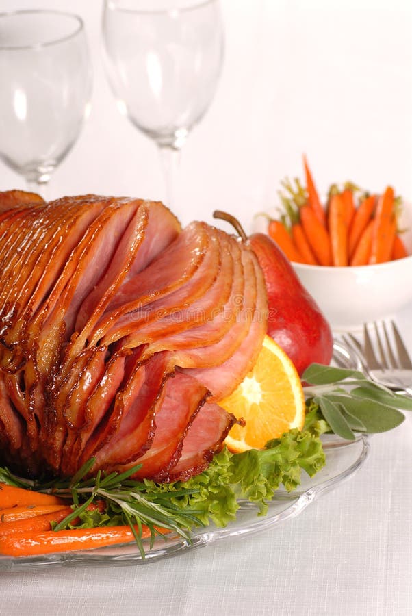 Honey and brown sugar glazed Easter ham with fruit and carrots. Honey and brown sugar glazed Easter ham with fruit and carrots
