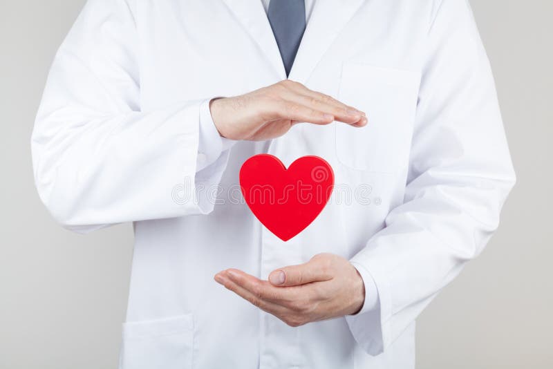 De handen van de artsencardioloog met vliegend hart Cardiologie en hartkwaalconcept