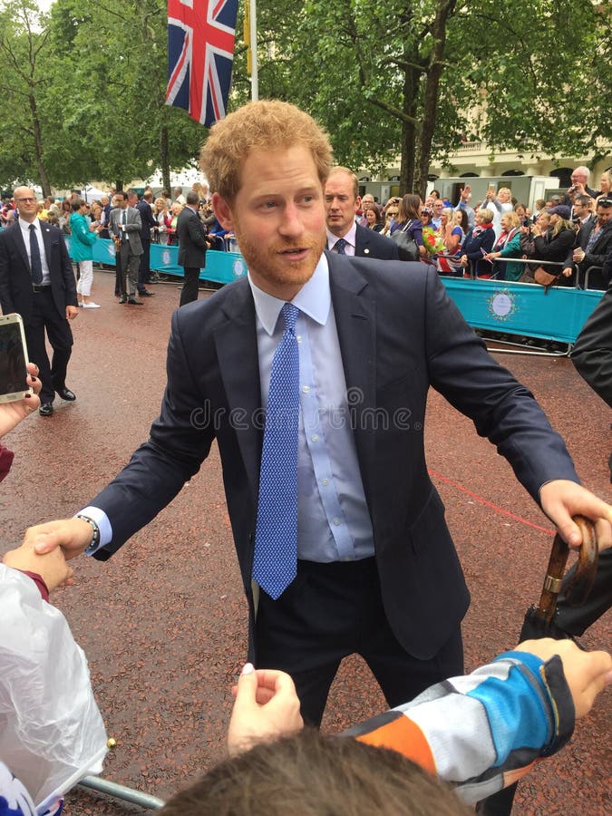 Prince Harry Windsor of United Knigdom shaking hands of well wishers on the Mall for Queens Patrons lunch. Prince Harry Windsor of United Knigdom shaking hands of well wishers on the Mall for Queens Patrons lunch.