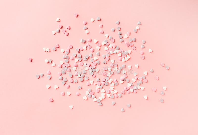 De hart-vormige decoratie van de suikercake op pastelkleur roze achtergrond