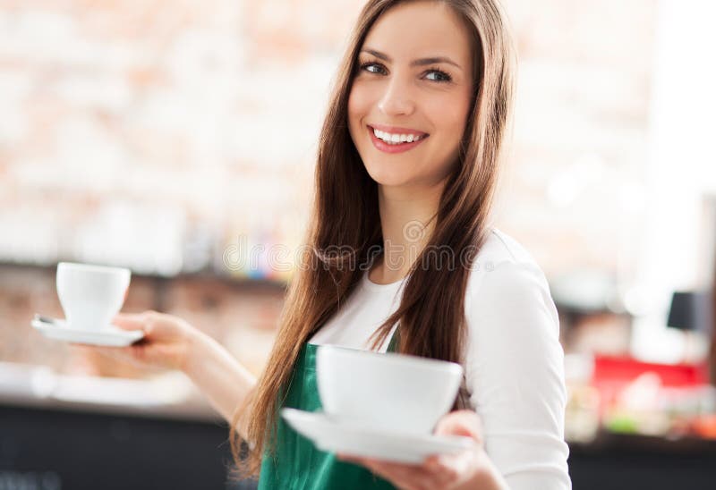 De dienende koffie van de serveerster stock afbeeldingen De dienende koffie van de serveerster stock afbeeldingen