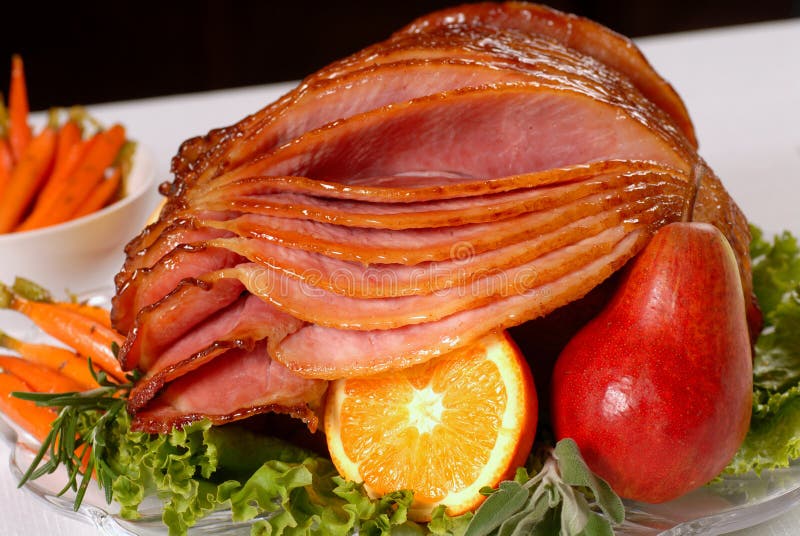 A spiral cut honey glazed Easter ham with fruit and carrots. A spiral cut honey glazed Easter ham with fruit and carrots