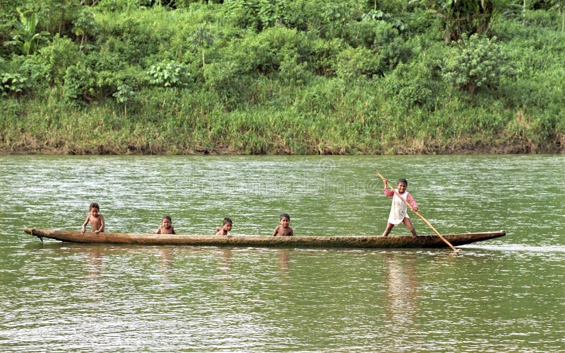 Nicaragua, San Andres village, on the border river Coco, Coco Rio in Spanish, between Nicaragua and Honduras is the home of Miskito Indians. The villages are situated on the upper parts of the river in the mountains. The villages, for these people, are only to reach by boat. This native children living on the Nicaraguan side of the river course. These Indian guys sail with a canoe on the waterway, learned young is done old. The tropical jungle, forest, on the other side of the river is the territory of Honduras. Nicaragua, San Andres village, on the border river Coco, Coco Rio in Spanish, between Nicaragua and Honduras is the home of Miskito Indians. The villages are situated on the upper parts of the river in the mountains. The villages, for these people, are only to reach by boat. This native children living on the Nicaraguan side of the river course. These Indian guys sail with a canoe on the waterway, learned young is done old. The tropical jungle, forest, on the other side of the river is the territory of Honduras.