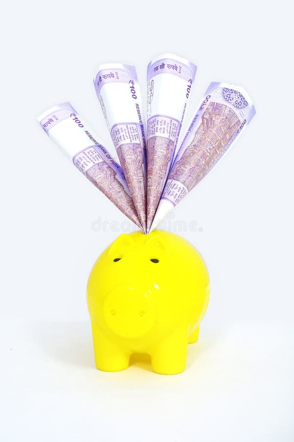 Indian 100 Rupee Currency Note in piggy bank. Isolated on the white background. Indian 100 Rupee Currency Note in piggy bank. Isolated on the white background.