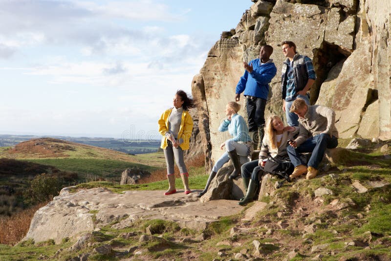 Young adults on country walk relaxing looking at the view. Young adults on country walk relaxing looking at the view