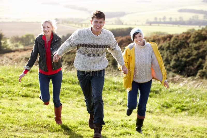 Young friends on country walk running. Young friends on country walk running