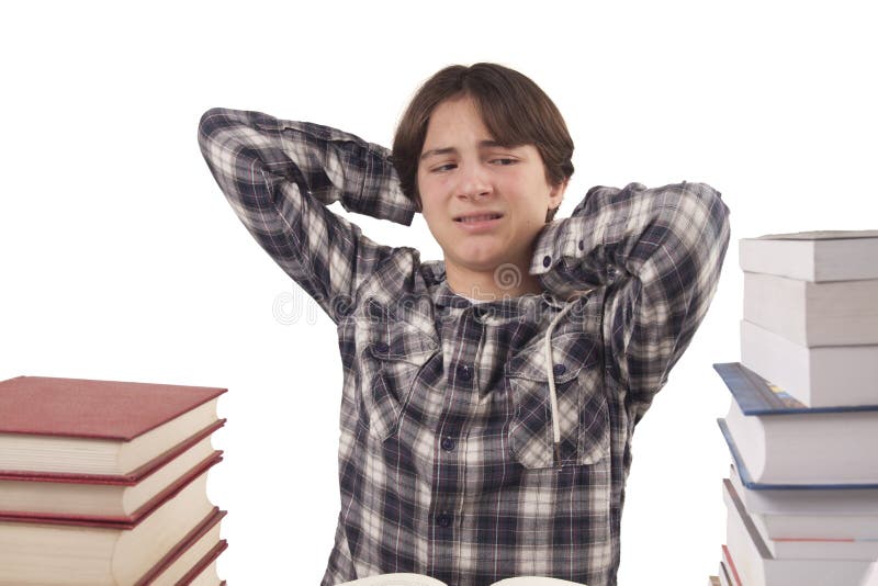 De jongen die van de tiener bij het bureau leren stock afbeelding De jongen die van de tiener bij het bureau leren stock afbeelding