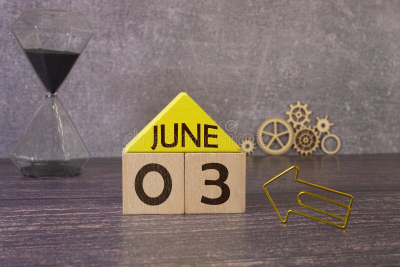 June 3. Date of June month. Number Cube with a flower and notebook on Diamond wood table for the background. June 3. Date of June month. Number Cube with a flower and notebook on Diamond wood table for the background