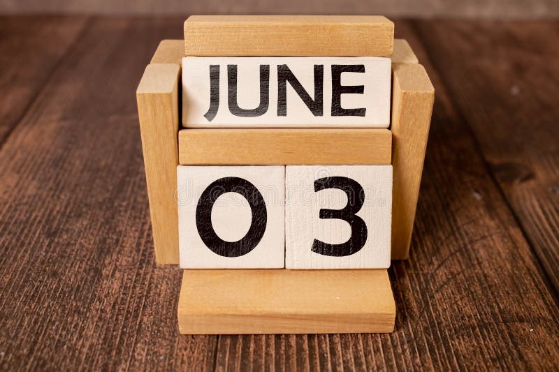 June 3. Date of June month. Number Cube with a flower and notebook on Diamond wood table for the background. June 3. Date of June month. Number Cube with a flower and notebook on Diamond wood table for the background