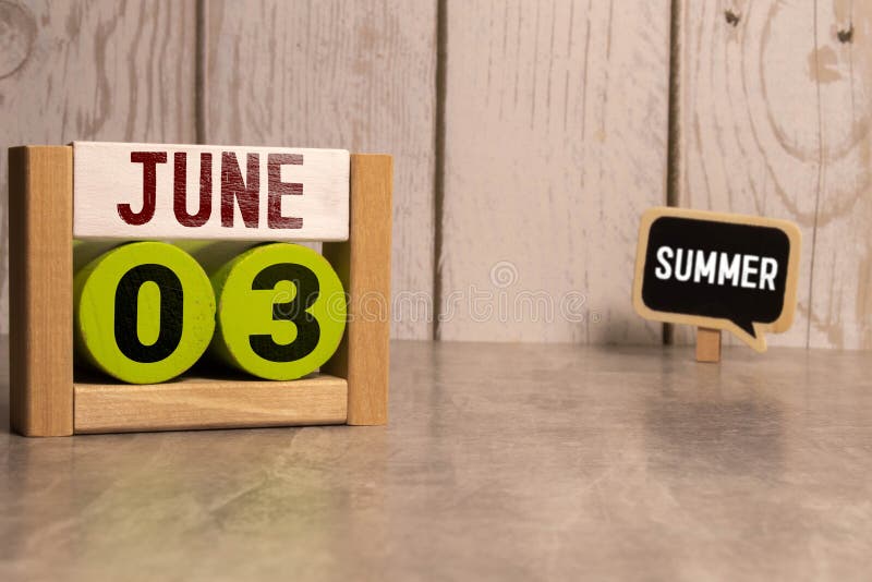 June 3. Date of June month. Number Cube with a flower and notebook on Diamond wood table for the background. June 3. Date of June month. Number Cube with a flower and notebook on Diamond wood table for the background