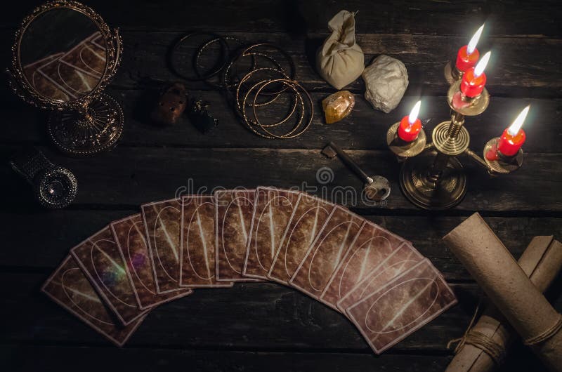 Tarot cards on fortune teller desk table background. Futune reading concept. Magic mirror and key to the fate. Tarot cards on fortune teller desk table background. Futune reading concept. Magic mirror and key to the fate.