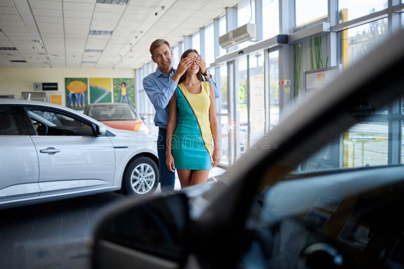 De kerel bereidde een verrassing voor zijn meisje voor Het kopen van een nieuwe auto stock afbeelding De kerel bereidde een verrassing voor zijn meisje voor Het kopen van een nieuwe auto stock afbeelding