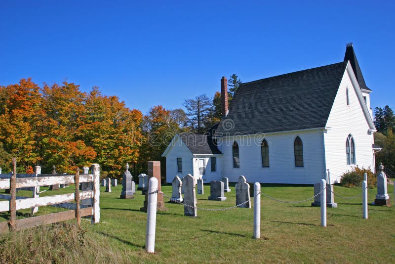 A small country church backed by the fall trees, with its little cemetery. A small country church backed by the fall trees, with its little cemetery.