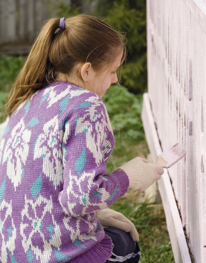 Children dye the porch of rural house in a pink color by brushes. Children dye the porch of rural house in a pink color by brushes