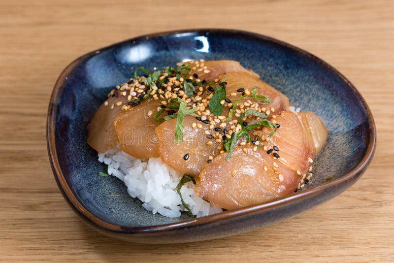 De kom met zalmsashimi kruidde met zwart-witte sesam, raket, norizeewier dat op een bed van gestoomde witte rijst wordt gebraden royalty-vrije stock foto's De kom met zalmsashimi kruidde met zwart-witte sesam, raket, norizeewier dat op een bed van gestoomde witte rijst wordt gebraden royalty-vrije stock foto's
