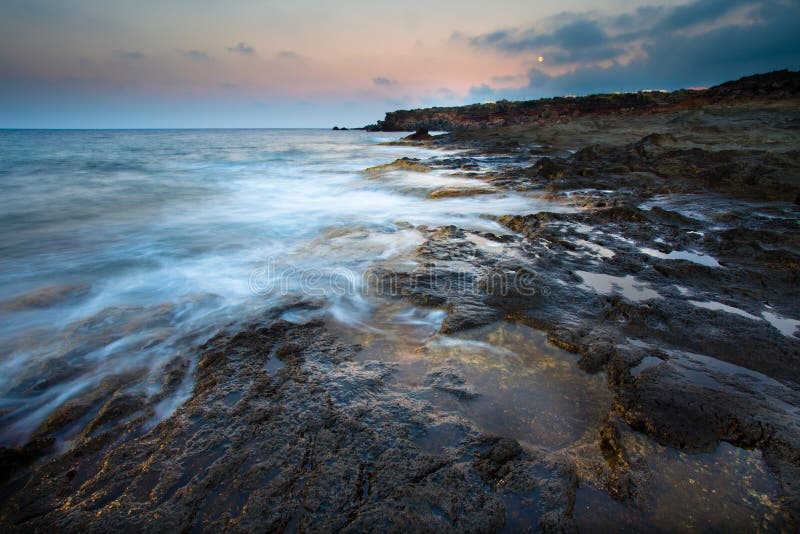 View of the sicilian coast with soft waves. View of the sicilian coast with soft waves.