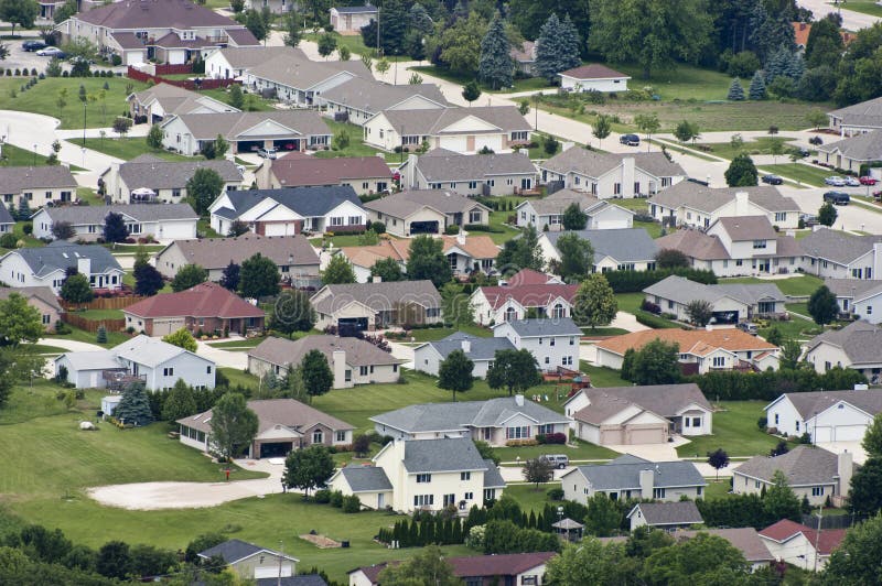 Aerial view of a modern neighborhood. Houses, homes, and family residences in a fairly new subdivision or a growing metropolitan city. Image could be used for many things such as housing, insurance, banking, finance, urban planning, politics, suburban living, families, and government. Aerial view of a modern neighborhood. Houses, homes, and family residences in a fairly new subdivision or a growing metropolitan city. Image could be used for many things such as housing, insurance, banking, finance, urban planning, politics, suburban living, families, and government.