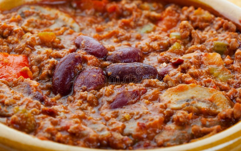 A closeup of chili con carne in a bowl. A closeup of chili con carne in a bowl.
