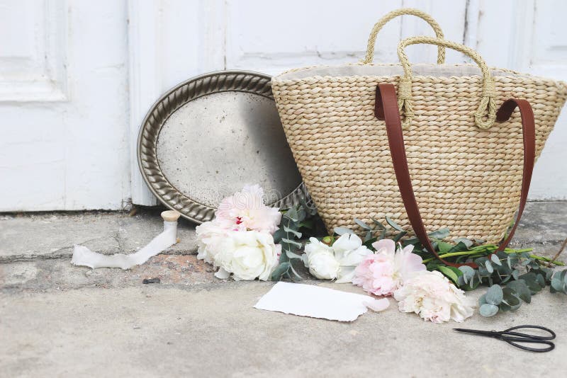 De mariage toujours composition féminine en vie avec le sac français de panier de paille, fleurs roses de pivoines, eucalyptus, a photo stock De mariage toujours composition féminine en vie avec le sac français de panier de paille, fleurs roses de pivoines, eucalyptus, a photo stock