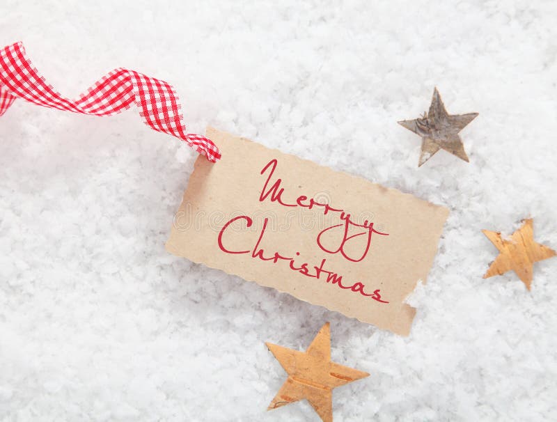 De markering van de gift met de Vrolijke groet van Kerstmis stock afbeelding De markering van de gift met de Vrolijke groet van Kerstmis stock afbeelding