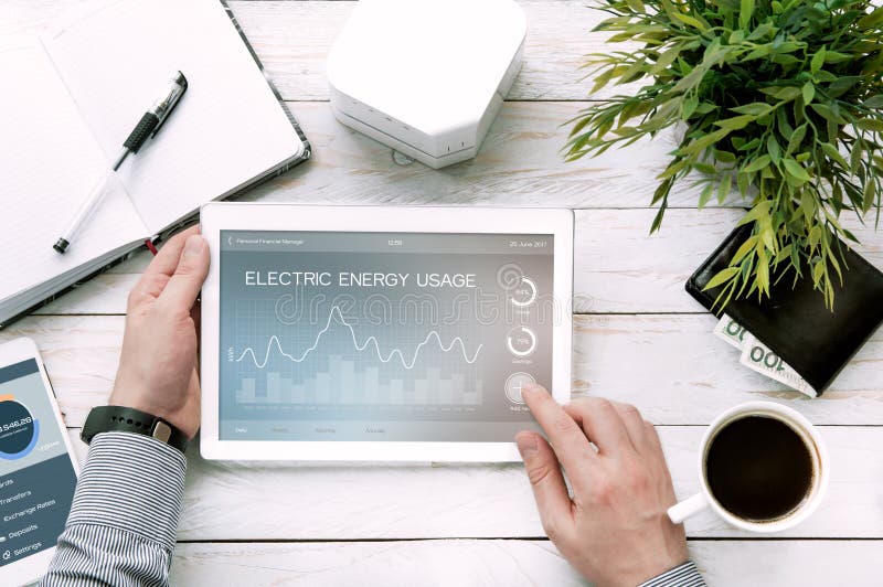 Man holds tablet pc with electric energy usage application made in graphic program. Man holds tablet pc with electric energy usage application made in graphic program