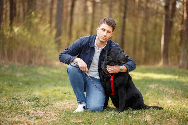 De mens met een hond loopt in aard op een de lentedag royalty-vrije stock foto's De mens met een hond loopt in aard op een de lentedag royalty-vrije stock foto's